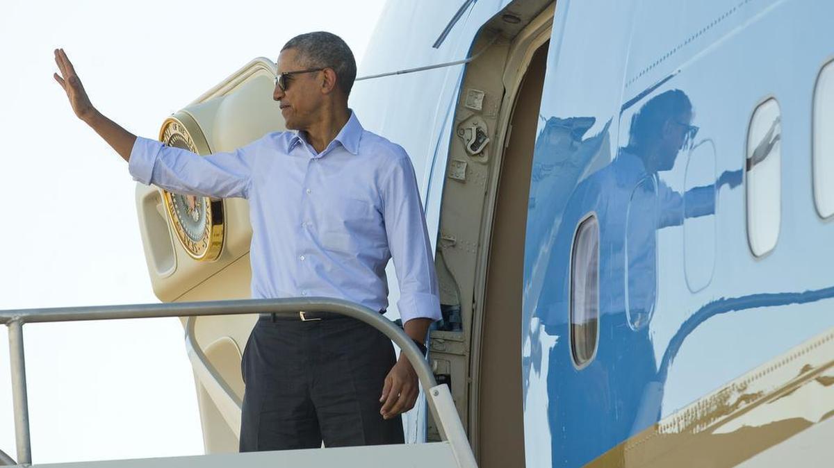 President Barack Obama waves as he boards Air Force One at Palm Springs International Airport on Tuesday. Obama is expected to visit Cuba next month as the two countries continue their efforts to normalize relations after a half-century of Cold War opposition.