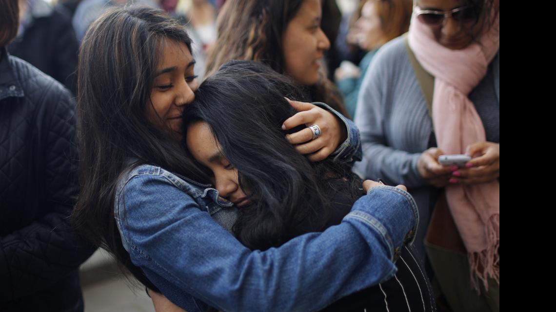 
Two young girls comfort each other outside a school in Barcelona, Spain, Monday, April 20, 2015. A student walked into a Barcelona school Monday morning and killed a teacher and wounded several other high school students on the 16th anniversary of the massacre of students in shootings at Columbine High School in the U.S. state of Colorado. 
