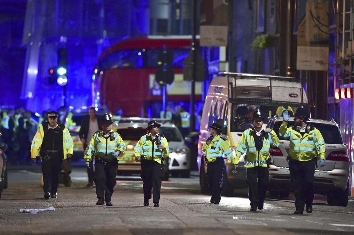 Police officers on Borough High Street as police are dealing with an incident on London Bridge in London, Saturday, June 3, 2017. Witnesses reported a vehicle hitting pedestrians and injured people on the ground.