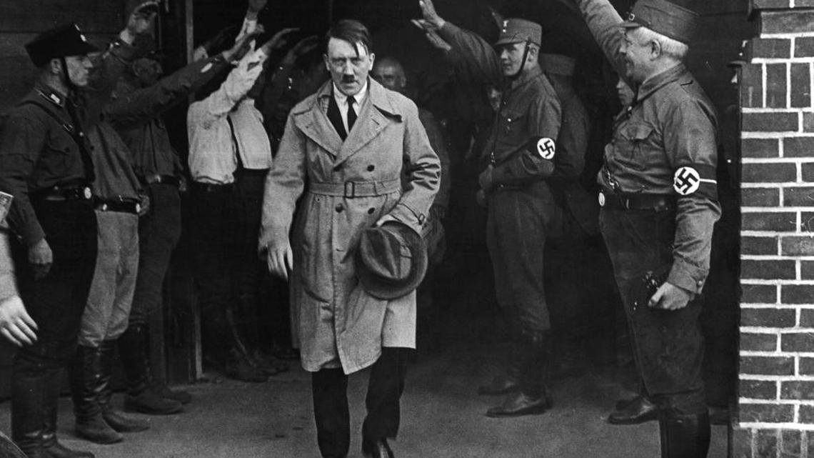Adolf Hitler emerges from the Nazi party's Munich headquarters. Historical documents show Hitler enjoyed special treatment, including plentiful supplies of beer, during his time in Landsberg prison.