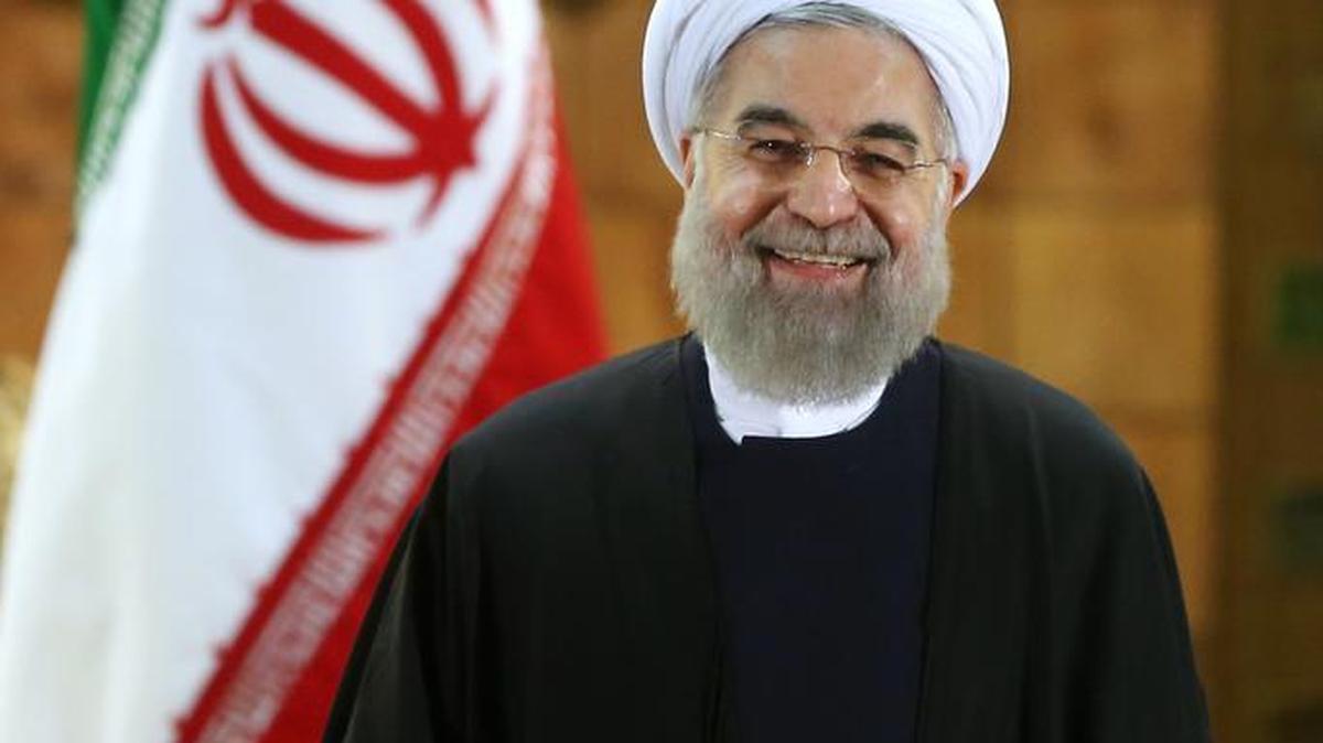 Iran’s President Hassan Rouhani beams during a press conference, in Tehran, Iran, on Sunday, Jan. 17, 2016. The implementation of a historic nuclear deal with world powers is expected to pave the way for a new economic reality in Iran, now freed from harsh international sanctions. On Sunday, Rouhani presented parliament with a draft budget that plans for an economic windfall, even as it reduces reliance on oil revenues.