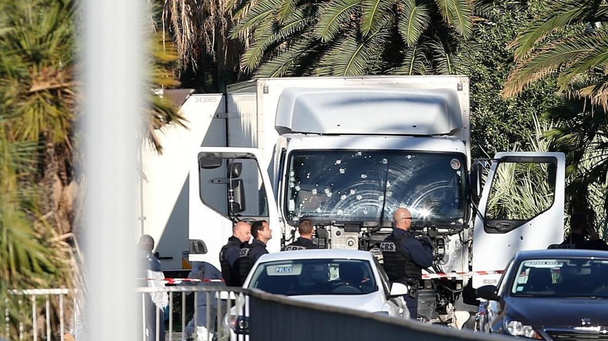 The truck which slammed into revelers late Thursday is seen at the site of the attack in Nice, southern France, Friday, July 15, 2016. The large truck mowed through revelers gathered for Bastille Day fireworks in Nice, killing more than 80 people and sending people fleeing into the sea as it bore down for more than a mile along the Riviera city's famed waterfront promenade.