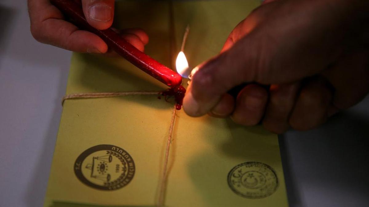 Turkish election officials seal the vote envelopes shortly after the polling stations closed in Istanbul at the end of the election day on Sunday, Nov. 1, 2015. Turks headed to the polls Sunday for the second time in five months in what is being seen as a crucial general election that will determine whether the ruling party can restore the parliamentary majority it enjoyed for the past 13-years.