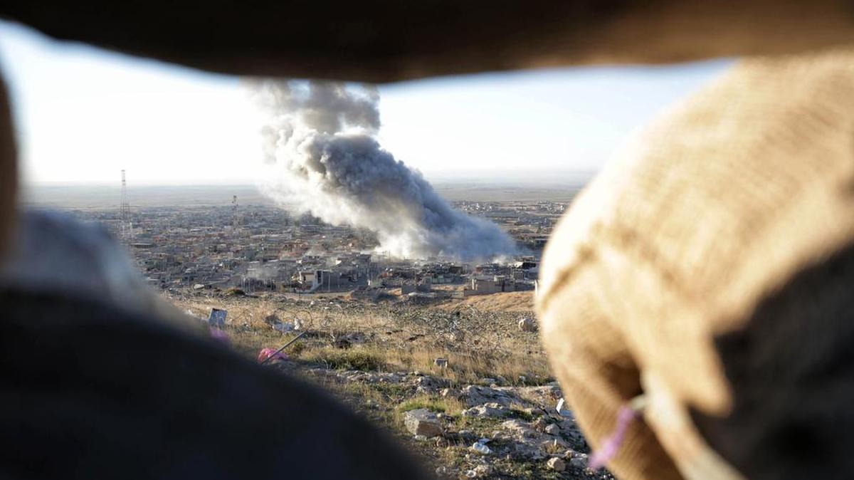 Smoke believed to be from an airstrike billows over the northern Iraqi town of Sinjar on Thursday, Nov. 12, 2015. Kurdish Iraqi fighters, backed by the U.S.-led air campaign, launched an assault Thursday aiming to retake the strategic town of Sinjar, which the Islamic State overran last year in an onslaught that caused the flight of tens of thousands of Yazidis and first prompted the U.S. to launch airstrikes against the militants.
