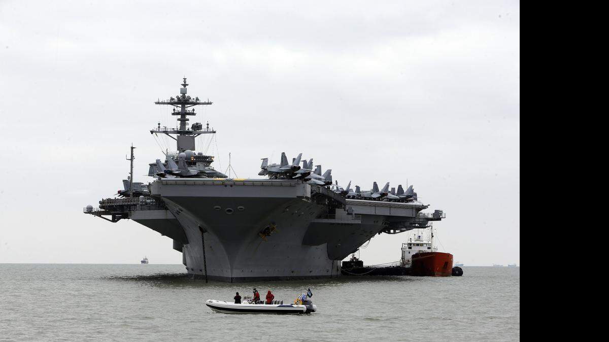 
The US aircraft carrier USS Theodore Roosevelt, at anchor off the United Kingdom's south coast Monday March 23, 2015. Navy officials say the aircraft carrier is steaming toward the waters off Yemen and will join other American ships prepared to intercept any Iranian vessels carrying weapons to the rebels fighting in Yemen. 
