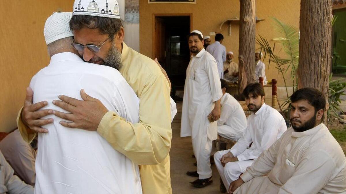 
Pakistani men visit and try to comfort Nasir Khan, second left, who lost his brother in a crush during the Hajj pilgrimage in Saudi Arabia, Sunday, Sept. 27, 2015, in Peshawar, Pakistan.
