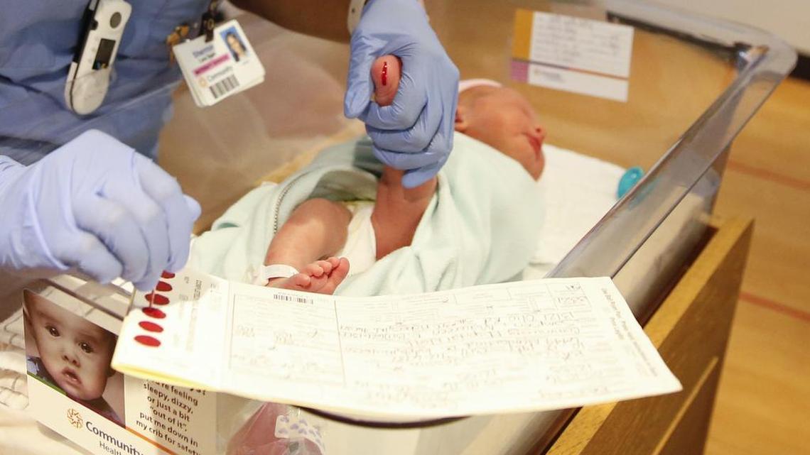 In this Thursday, May 12, 2016, photo, obstetrician technician Sherron Harris collects a blood sample from newborn Ellie Bailey in the nursery at Community Hospital North in Indianapolis.