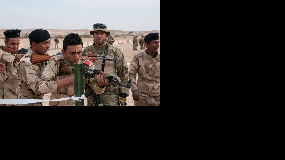 
A Danish trainer tells an Iraqi army trainee, 2nd from left, to correct his weapon’s position during simulated room clearing exercises on Feb. 10, 2015, as part of multinational efforts in helping combat the Islamic State militant group in Iraq. Questions persist about whether the struggling Iraqi military will be ready for the operation to retake Mosul, the country’s second largest city, from Islamic State militants in just a few months. 
