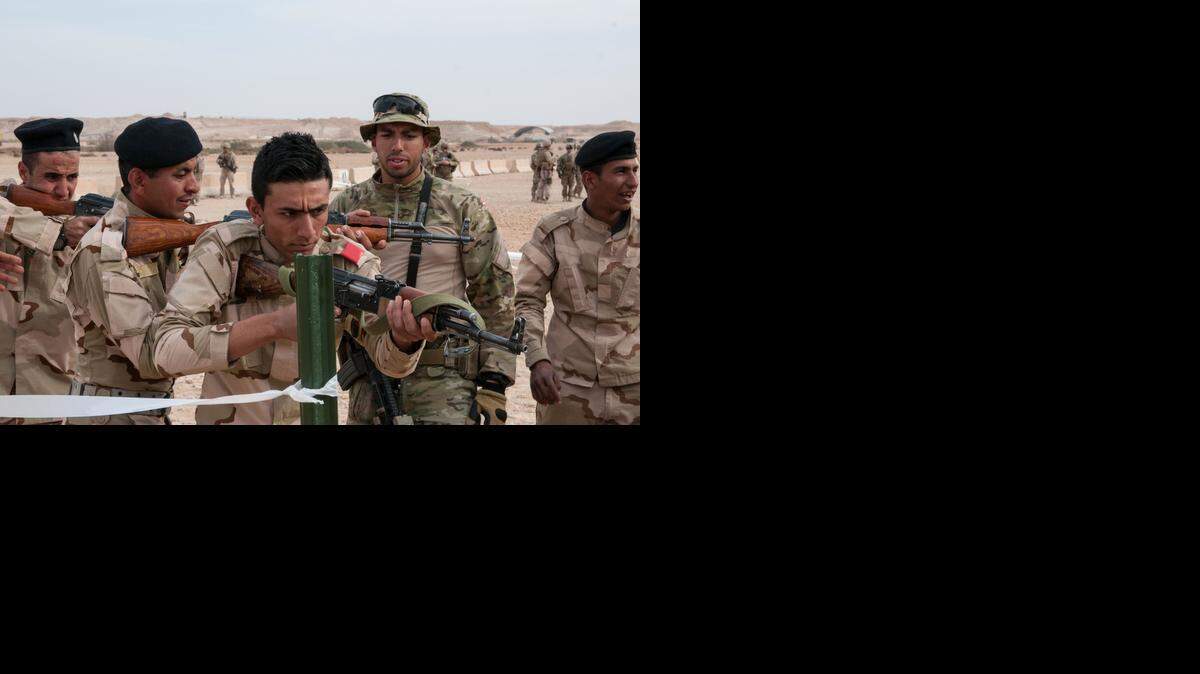 
A Danish trainer tells an Iraqi army trainee, 2nd from left, to correct his weapon’s position during simulated room clearing exercises on Feb. 10, 2015, as part of multinational efforts in helping combat the Islamic State militant group in Iraq. Questions persist about whether the struggling Iraqi military will be ready for the operation to retake Mosul, the country’s second largest city, from Islamic State militants in just a few months. 
