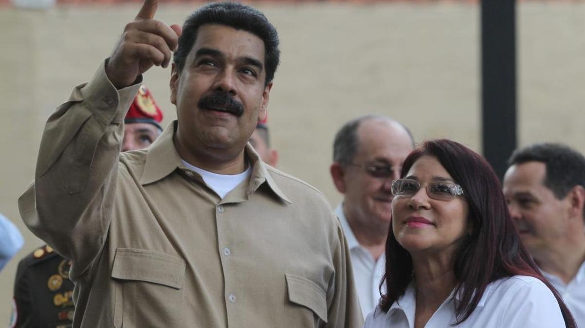 Venezuela's President Nicolas Maduro speaks with his wife, Cilia Flores, as they wait for Colombia's President Juan Manuel Santos before a meeting in Puerto Ordaz, Venezuela, on Aug. 11, 2016.