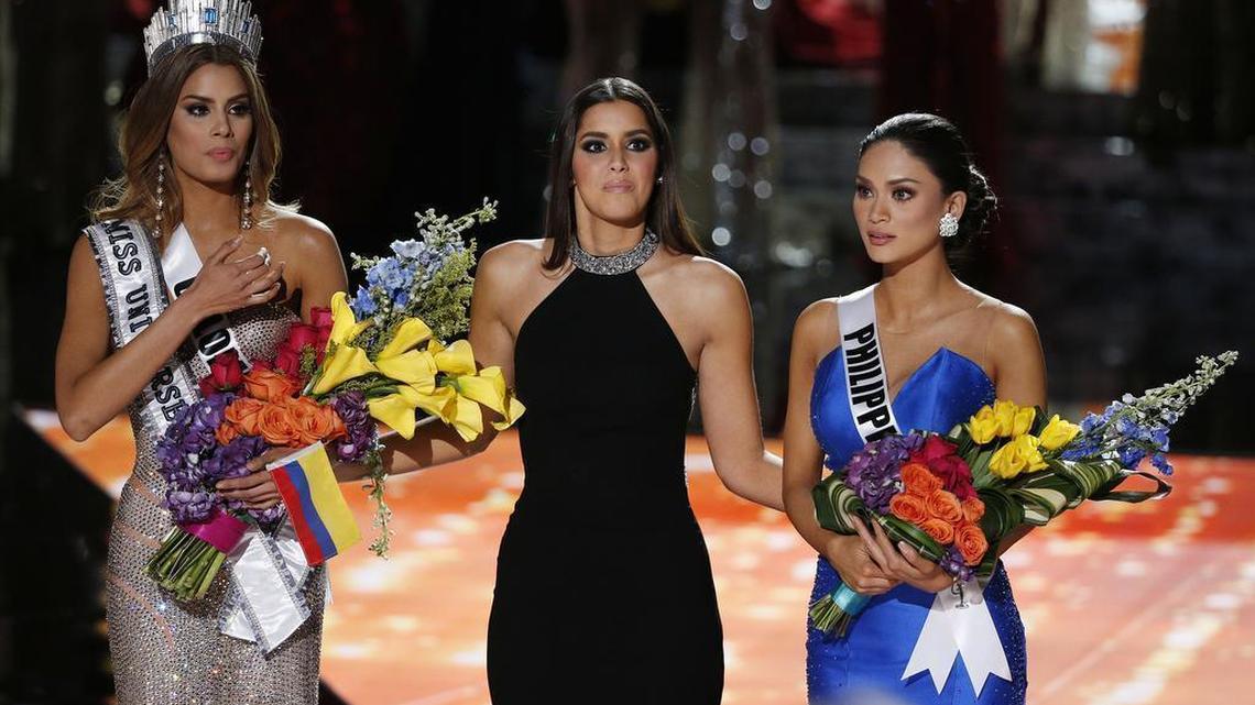 Former Miss Universe Paulina Vega, center, reacts before taking away the flowers, crown and sash from Miss Colombia Ariadna Gutierrez, left, before giving it to Miss Philippines Pia Alonzo Wurtzbach at the Miss Universe pageant Sunday in Las Vegas. Gutierrez was incorrectly named Miss Universe.