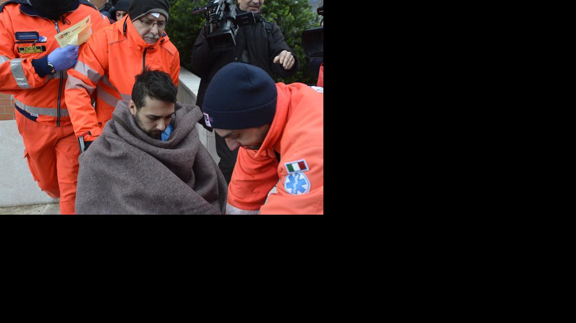 
Rescuers assist a passenger of the Italian-flagged Norman Atlantic, that caught fire in the Adriatic Sea, in Bari harbor, southern Italy, Monday, Dec. 29, 2014. A ferry carrying nearly 500 people caught fire off the Greek island of Corfu early Sunday, trapping passengers on the top decks as gale-force winds and choppy seas hampered the evacuation. Greek and Italian rescue helicopters and vessels struggled to reach the stricken ferry, with nearby merchant ships lining up to form a wall against the raging gusts. 
