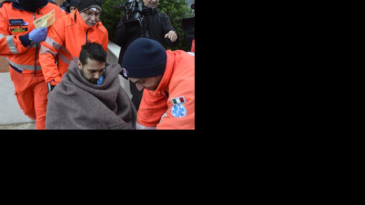 
Rescuers assist a passenger of the Italian-flagged Norman Atlantic, that caught fire in the Adriatic Sea, in Bari harbor, southern Italy, Monday, Dec. 29, 2014. A ferry carrying nearly 500 people caught fire off the Greek island of Corfu early Sunday, trapping passengers on the top decks as gale-force winds and choppy seas hampered the evacuation. Greek and Italian rescue helicopters and vessels struggled to reach the stricken ferry, with nearby merchant ships lining up to form a wall against the raging gusts. 
