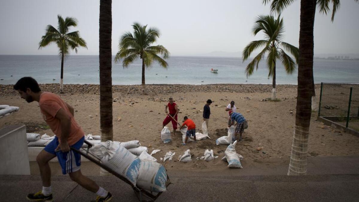 Residents prepare for the arrival of Hurricane Patricia by filling sand bags to protect beachfront businesses, in Puerto Vallarta, Mexico, Friday, Oct. 23, 2015.