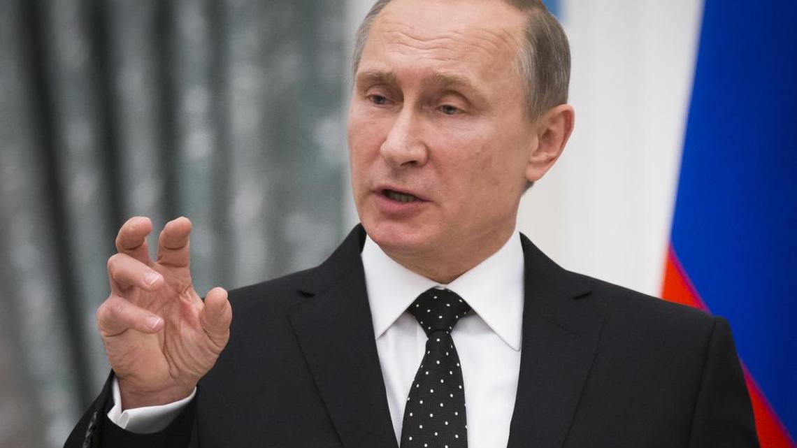 Russian President Vladimir Putin addresses media during his and France’s President Francois Hollande news conference following talks in Moscow on Thursday, Nov. 26, 2015. Putin and visiting French President Francois Hollande agreed to share intelligence information and cooperate on selecting targets in the fight against the Islamic State group, raising hope for closer ties between Moscow and the U.S.-led coalition fighting the Islamic State group following the Paris attacks. In addition, Putin has called for a ban on some goods and forbidden extensions of labor contracts for Turks working in Russia as of Jan. 1, following news that Turkey downed a Russian plane in Egypt.