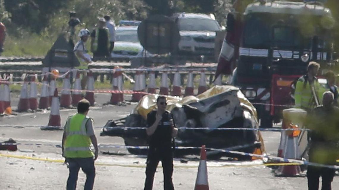 
Emergency services attend the scene on the A27 after a plane crashed into cars on the major road during an aerial display at the Shoreham Airshow in West Sussex, England, on Saturday, Aug. 22, 2015. A military jet taking part in a British airshow crashed into a busy main road, killing seven people and injuring more than a dozen others, police said Saturday. The Hawker Hunter fighter jet, which was participating in the Shoreham Airshow near Brighton in southern England, hit several vehicles on the road as it crashed Saturday afternoon. Witnesses told local TV that the jet appeared to have plummeted when it failed to pull out of a loop maneuver. 
