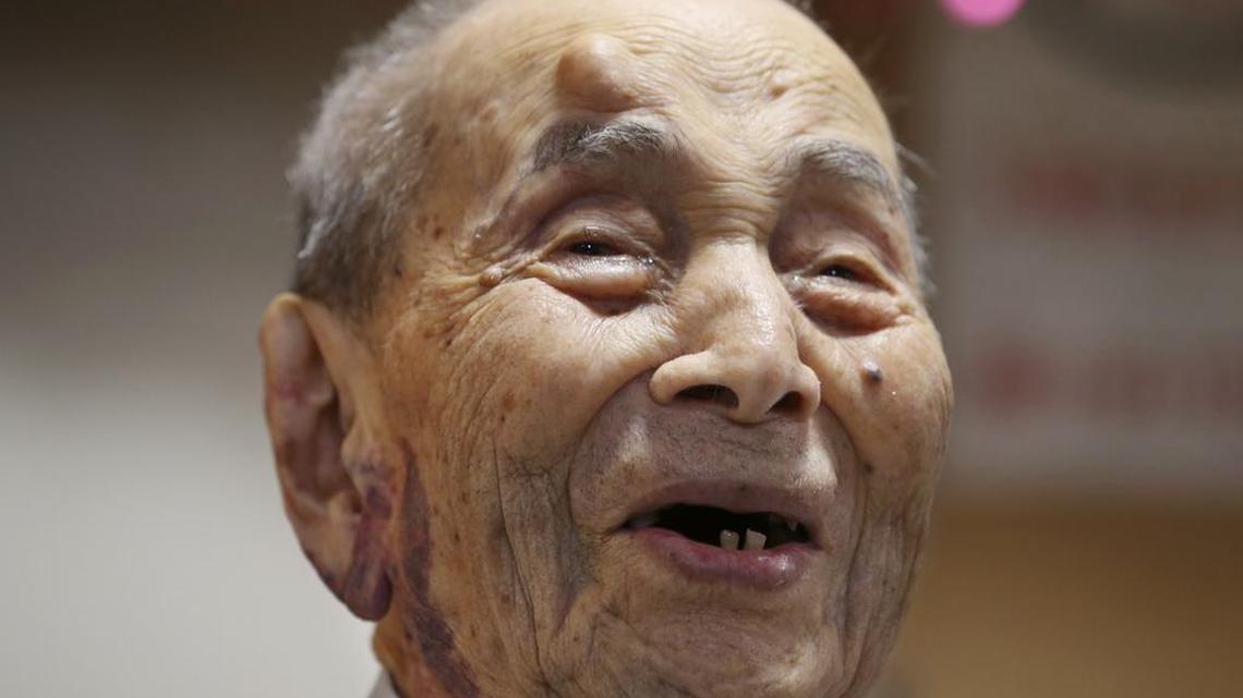 Yasutaro Koide smiles upon being formally recognized as the world’s oldest man by the Guinness World Records at a nursing home in Nagoya, central Japan, on Aug. 21, 2015.