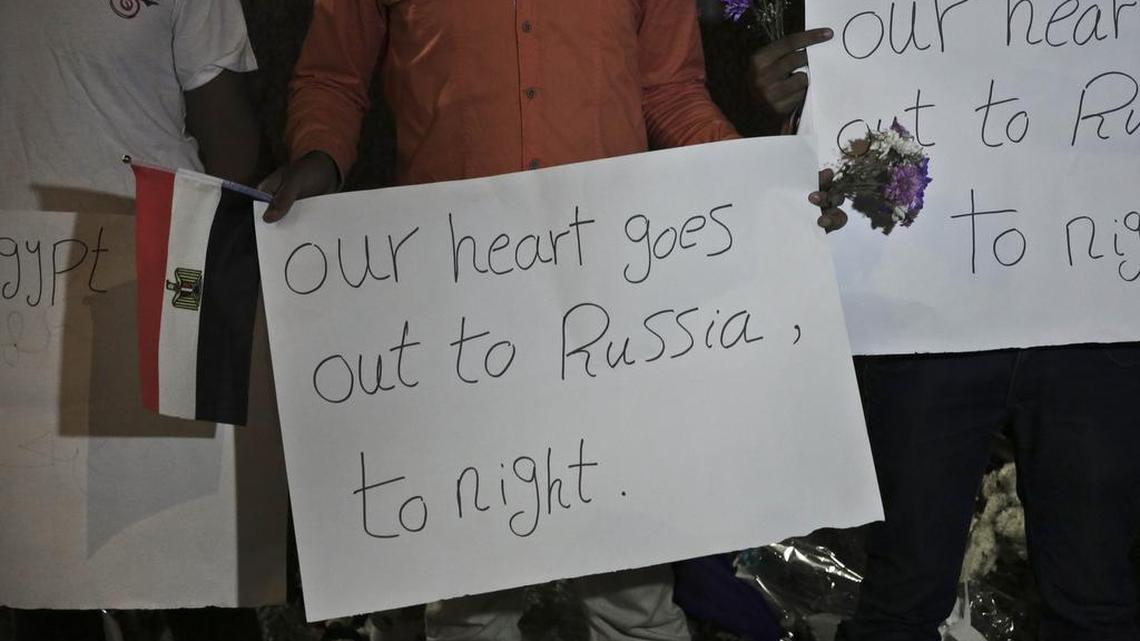 Members from the Egyptian Youth Movement hold signs during a gathering to commemorate the death of plane crash victims outside the Russian embassy in Cairo on Sunday, Nov. 1, 2015. A Russian passenger airliner crashed Saturday in a remote mountainous part of Egypt’s Sinai Peninsula 23 minutes after taking off from a popular Red Sea resort, killing all 224 people on board.