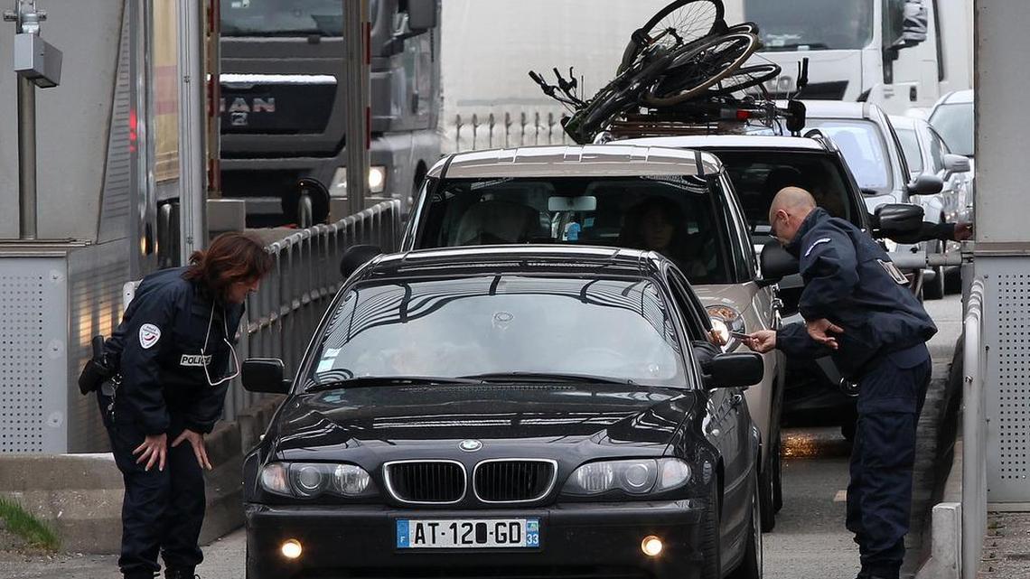French police officers check vehicles leaving France at the border crossing between France and Spain in Biriatou, as southwestern France, Saturday, Nov. 14, 2015.