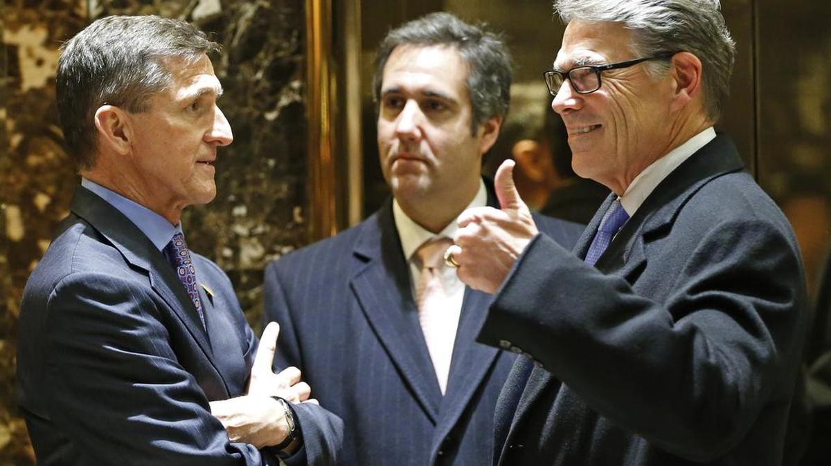 Retired U.S. Army Lieutenant General Michael T. Flynn, left, chats with former Texas Gov. Rick Perry, right, and Trump attorney Michael D. Cohen, center, in the lobby at Trump Tower, Monday, Dec. 12, 2016, in New York.