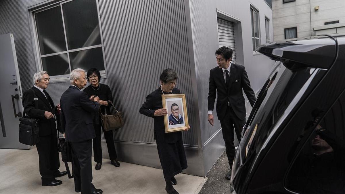 Relatives of Hajime Iguchi depart Sousou, a so-called corpse hotel, en route to a crematory in Kawasaki City, Japan, Sept. 12, 2016. Part mortuary, part inn, these hotels serve a growing market in a country where the population is aging rapidly, community bonds are fraying and crematories are struggling to keep up with the sheer number of people dying.