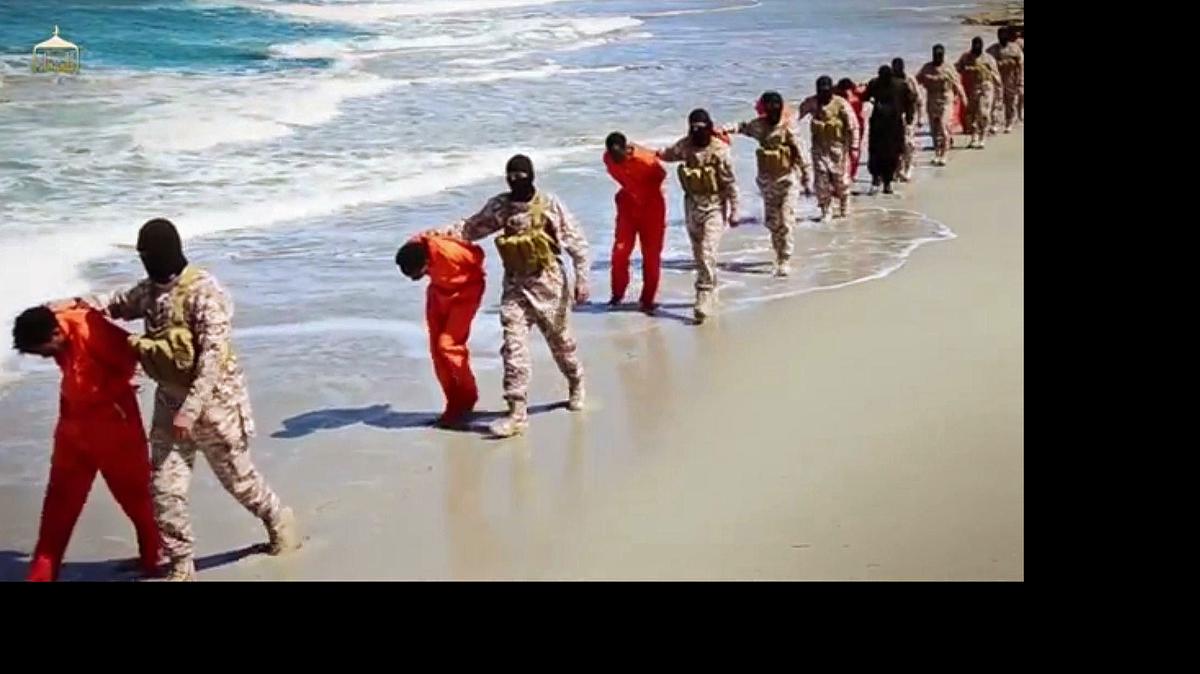 
EDS NOTE: GRAPHIC CONTENT - This undated image made from a video released by Islamic State militants, Sunday, April 19, 2015, appears to show the killing of a group of captured Ethiopian Christians in Libya. The 29-minute video released online Sunday purportedly shows two groups of captives. It says one group is held by an IS affiliate in eastern Libya and the other by an affiliate in the south. A masked fighter delivers a long statement before the video switches between footage that purportedly shows the captives in the south being shot dead and the captives in the east being beheaded on a beach. 
