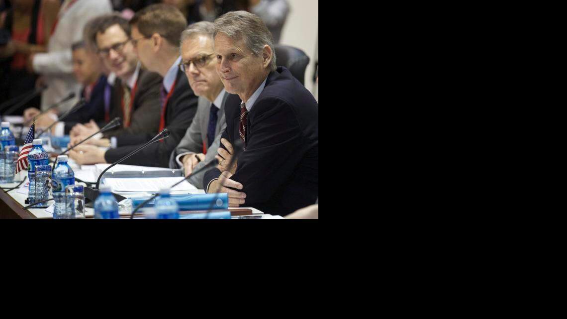 
Deputy Assistant Secretary at the U.S. State Department's Bureau of Western Hemisphere Affairs Edward Alex Lee, right, and members of a U.S. delegation, sit across from Cuban delegates as they begin negotiations, in Havana, Cuba, Wednesday, Jan. 21, 2015. The highest-level U.S. delegation to Cuba in decades kicked off two days of negotiations Wednesday after grand promises by President Barack Obama about change on the island and a somber warning from Cuba to abandon hopes of reforming the communist government. 
