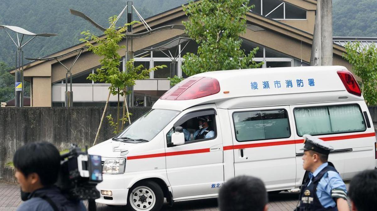 An ambulance moves past in front of a facility for the handicapped where a number of people were killed and dozens injured in a knife attack Tuesday, July 26, 2016, in Sagamihara, outside Tokyo.