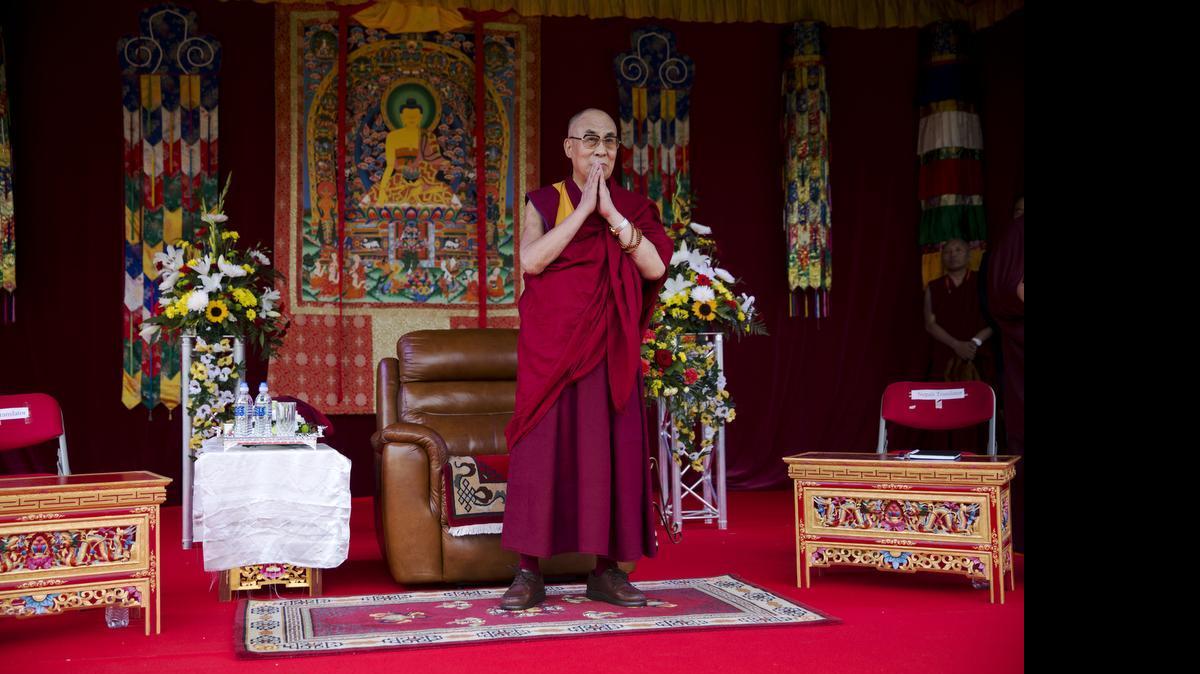 
Buddhist spiritual leader the Dalai Lama stands to make a speech to an audience at the ESS Stadium in Aldershot, southern England,on Monday, June 29, 2015. Before the speech on Monday, the exiled Tibetan spiritual leader inaugurated the Buddhist Community Centre UK. 
