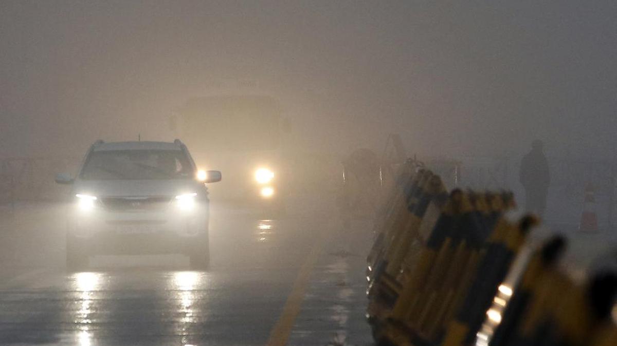 South Korean vehicles pass near the military barricade as a soldier, right, stands in the foggy and rainy morning at Unification Bridge near the border village of Panmunjom in Paju, South Korea, Friday, Feb. 12, 2016. North Korea on Thursday ordered a military takeover of a factory park that had been the last major symbol of cooperation with South Korea, calling Seoul's earlier suspension of operations at the jointly run facility as punishment for the North's recent rocket launch a "dangerous declaration of war."