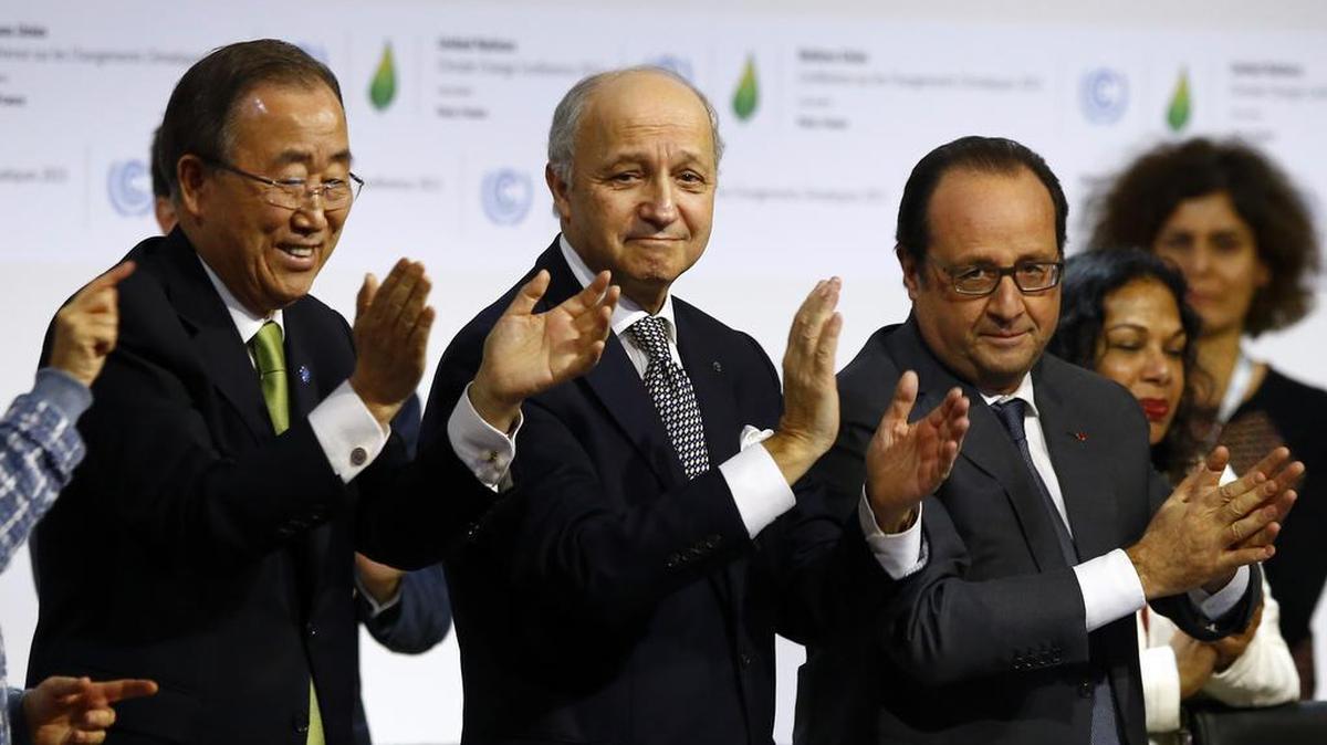 French President Francois Hollande, right, French Foreign Minister and president of the COP21 Laurent Fabius, center, and United Nations Secretary General Ban ki-Moon applaud after the final conference at the COP21, the United Nations conference on climate change, in Le Bourget, north of Paris, Saturday, Dec.12, 2015. Governments have adopted a global agreement that for the first time asks all countries to reduce or rein in their greenhouse gas emissions.