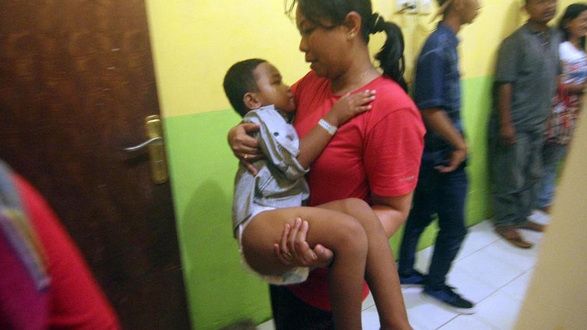 A paramedic carries a 4-year-old boy identified as Rafli who survived the ferry that sank off Sulawesi island at a hospital in Siwa, South Sulawesi, Indonesia, on Sunday, Dec. 20, 2015. Rescuers have pulled out dozens of survivors and a number of dead from the passenger boat that sank in central Indonesia after being buffeted by high waves, and were battling bad weather Sunday to reach scores of others still missing.