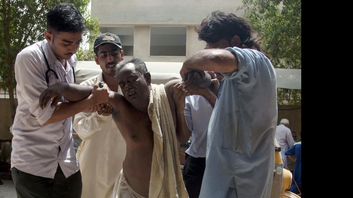 
In this June 23, 2015, photo, people rush a patient to a hospital suffering from heatstroke in Karachi, Pakistan. June was warm nearly all over, with exceptional heat in Spain, Austria, parts of Asia, Australia and South America. Pakistan reported a June heat wave that killed more than 1,200 people, which according to an international database would be the 8th deadliest in the world since 1900. 
