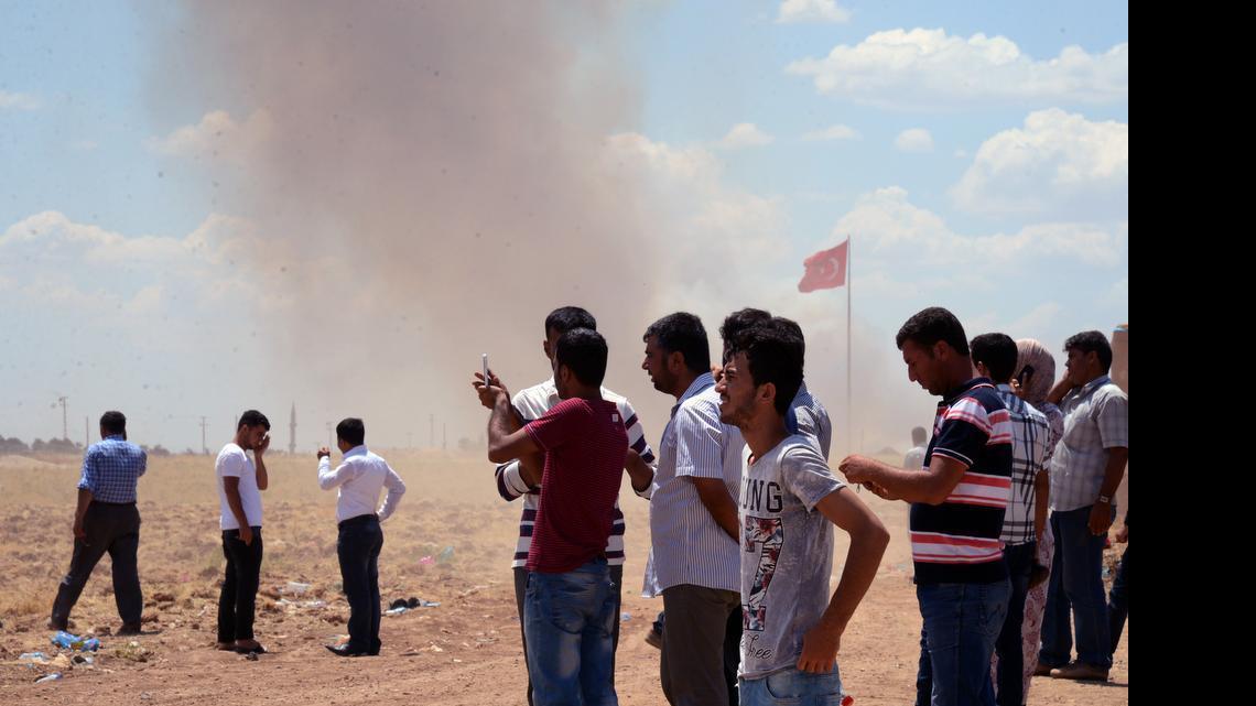 
Turkish Kurds watch the situation in Kobani, Syria, from the Turkish side of the border in Suruc, Turkey, Friday, June 26, 2015 as smoke rises in the area. Defense Secretary Ash Carter said Kurdish fighters from the YPG militia are identifying bombing targets for U.S.-led airstrikes.
