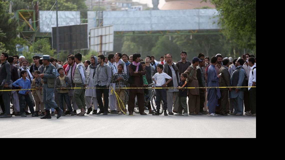 
 Afghans watch the aftermath of a suicide car bombing attack in Kabul, Afghanistan, on May 19, 2015. A study produced by Brown University's Watson Institute for International Studies looks at war-related deaths, injuries and displacement in Afghanistan and Pakistan from 2001 to last year, when international combat troops left Afghanistan. 
