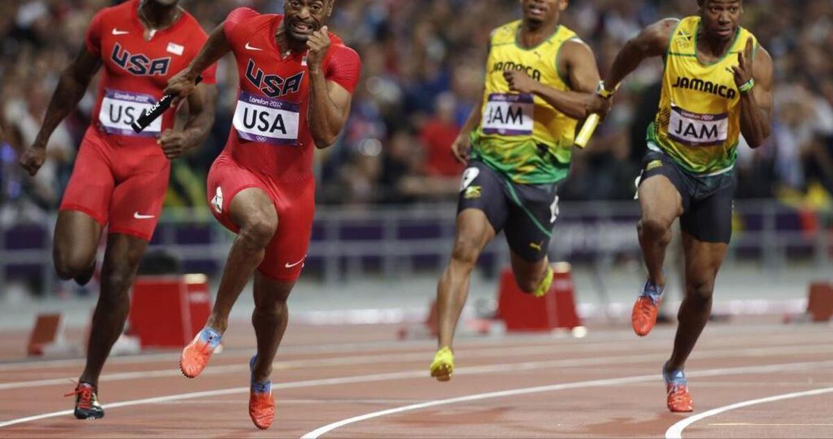 
In this Saturday, Aug. 11, 2012 file photo, from left, United States' Justin Gatlin hands the baton to Tyson Gay, as Jamaica's Michael Frater hands the baton to Yohan Blake in the men's 4x100-meter relay final during the athletics in the Olympic Stadium at the 2012 Summer Olympics, London. Two officials with knowledge of the decision say the entire U.S. men’s sprint relay team has been stripped of its silver medal from the 2012 London Olympics as a result of Tyson Gay’s doping case. 
