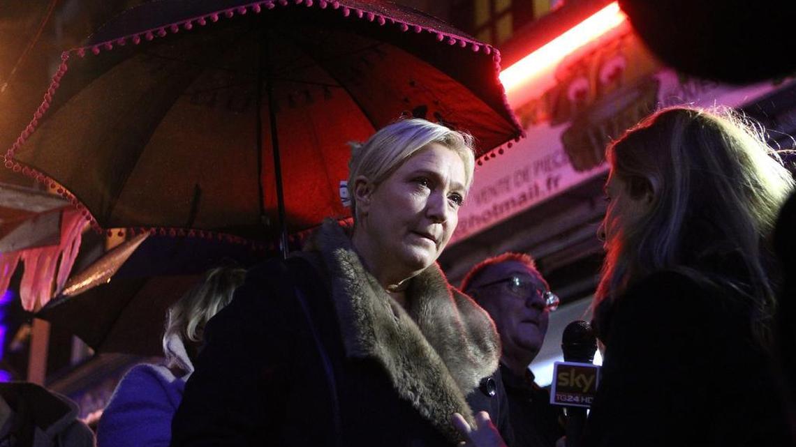 French far-right party leader Marine Le Pen speaks to the media during a visit at the Christmas market in Henin-Beaumont, northern France, Dec. 11, 2015. Le Pen is in the race for the presidency of the French northern region. The second round of the regional elections will take place Sunday.