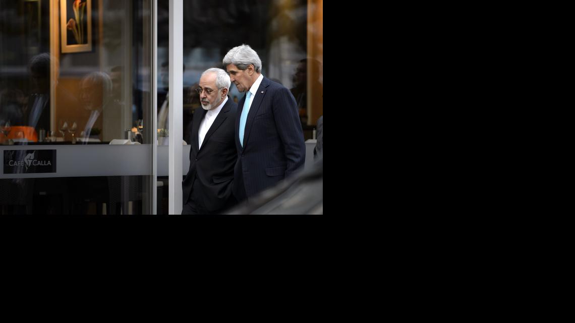 
In this file photo taken Wednesday, Jan. 14, 2015, U.S. Secretary of State John Kerry, right, speaks with Iranian Foreign Minister Mohammad Javad Zarif as they walk in Geneva, Switzerland, ahead of the next round of nuclear discussion. Zarif has borne the brunt of the hard-liners' most recent criticism, particularly over a walk he took with Kerry during negotiations in Geneva in January 2015. 
