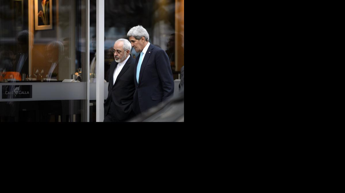 
In this file photo taken Wednesday, Jan. 14, 2015, U.S. Secretary of State John Kerry, right, speaks with Iranian Foreign Minister Mohammad Javad Zarif as they walk in Geneva, Switzerland, ahead of the next round of nuclear discussion. Zarif has borne the brunt of the hard-liners' most recent criticism, particularly over a walk he took with Kerry during negotiations in Geneva in January 2015. 
