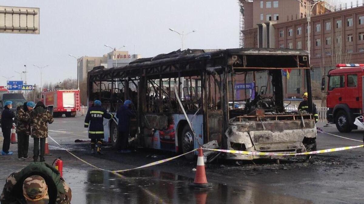 Firefighters work at an accident site of a bus fire in Yinchuan, the capital of Ningxia region, on Tuesday. The incident happened Tuesday morning and the cause of the fire is still being investigated, said a press officer at a local fire department.