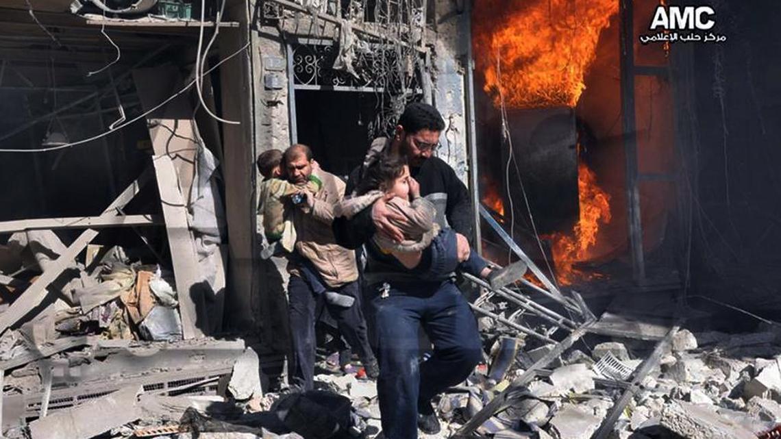 In this photo provided by the anti-government activist group Aleppo Media Center (AMC), which has been authenticated based on its contents and other AP reporting, Syrian men help survivors out of a destroyed building after a Syrian forces warplane's attack in Aleppo, Syria, Feb. 8, 2014. Syrian military aircraft dropped barrels bombs on rebel-held areas in the northern city of Aleppo on Saturday.