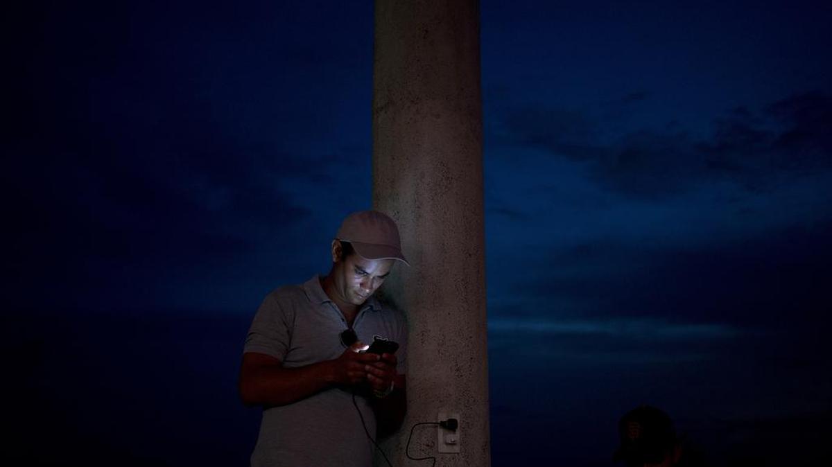 Cuban migrant Yannier Rodriguez checks his cellphone in La Cruz, Costa Rica, near the border with Nicaragua. Rodriguez joined a highly organized, well-funded and increasingly successful homebrewed effort to make human traffickers obsolete by using smartphones and messaging apps on much of the 3,400-mile overland journey that's become Cubans' main route to the U.S.