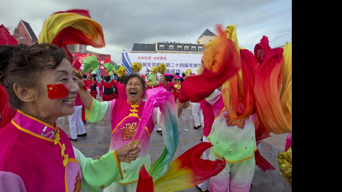 
Performers celebrate after Beijing is announced as the host city for the 2022 Winter Olympics at the ski resort region of Chongli where the Nordic skiing, ski jumping, and other outdoor Olympic events will be held in northern China's Hebei province Friday, July 31, 2015. Beijing was selected Friday to host the 2022 Winter Olympics, becoming the first city awarded both the winter and summer games. 
