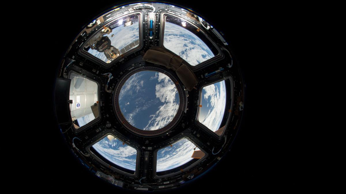 
A view of Earth as seen from the Cupola on the Earth-facing side of the International Space Station, June 12, 2013. Visible in the top left foreground is a Russian Soyuz crew capsule. In the lower right corner, a solar array panel can be seen. 
