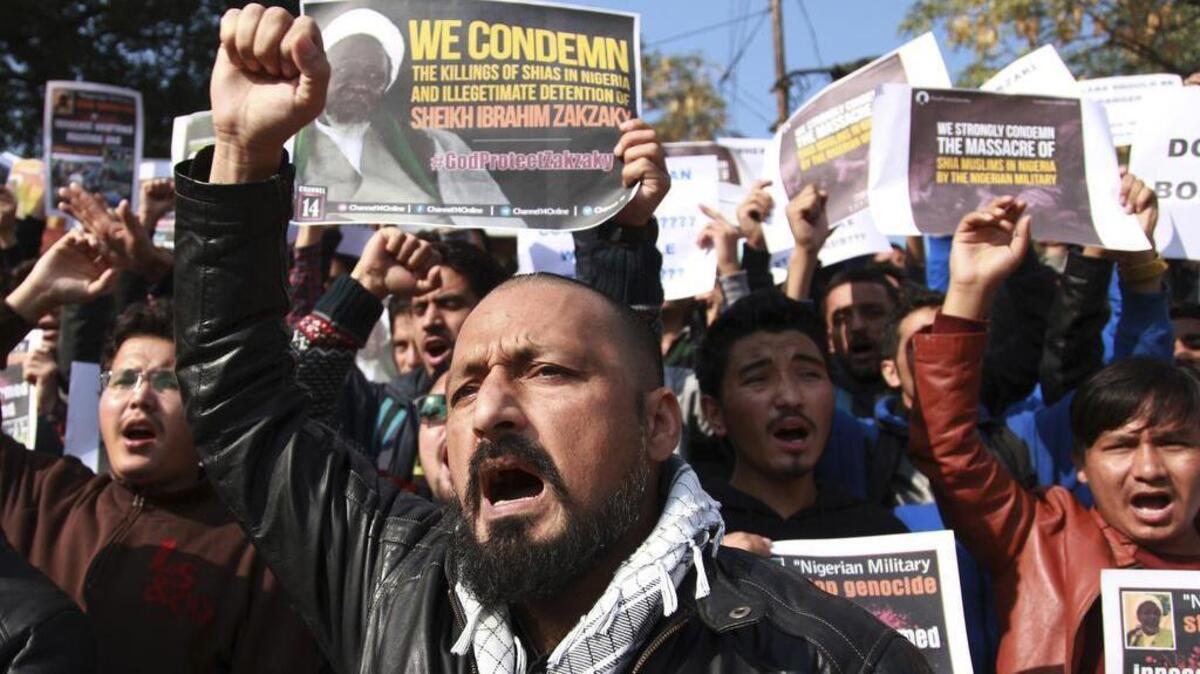 Muslims students in Jammu, India, carry placards and shout slogans Tuesday against the Nigerian government in the killings of hundreds of Shiite Muslims.