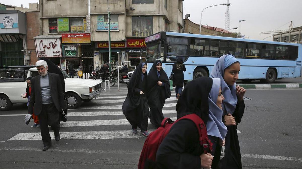 Iranian pedestrians cross a square in downtown Tehran, Iran,.
