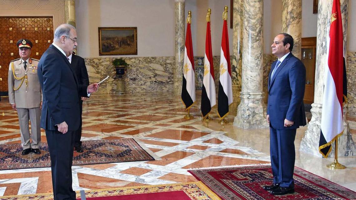 
In this photo provided by Egypt’s state news agency MENA, Egyptian President Abdel-Fattah el-Sissi, right, presides over the swearing in of Prime Minister Sheriff Ismail one week after the previous Cabinet resigned amid a corruption probe, in Cairo, Egypt, on Saturday, Sept. 12, 2015. El-Sissi has also restructured the Cabinet, merging several ministries and forming a new body responsible for immigration, according to the Middle East News Agency. The 33-member Cabinet contains three women and 16 new members. 
