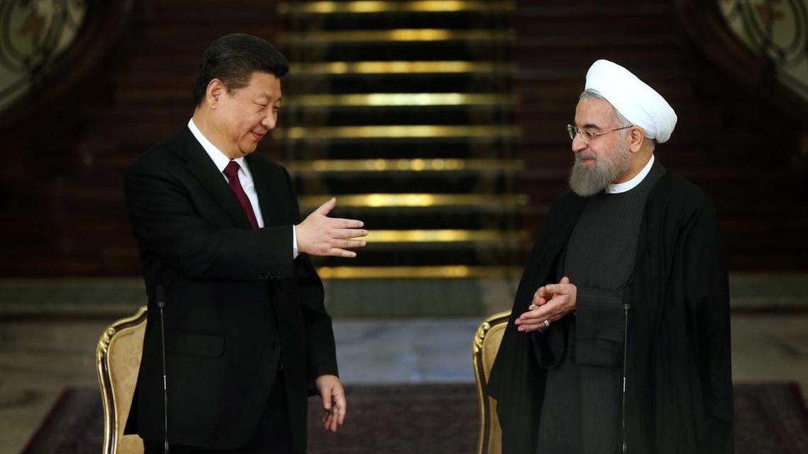 Chinese President Xi Jinping, left, and his Iranian counterpart, Hassan Rouhani, prepare to shake hands at the conclusion of their joint press conference at the Saadabad Palace in Tehran, Iran, Saturday, Jan. 23, 2016.