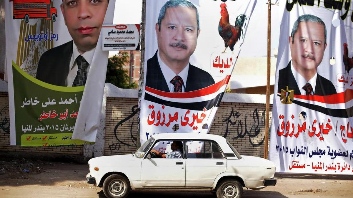 
Billboards for candidates are posted outside the polling station during the first round of Egyptian parliamentary elections, in Minya, south of Cairo, on Sunday, Oct. 18, 2015. 
