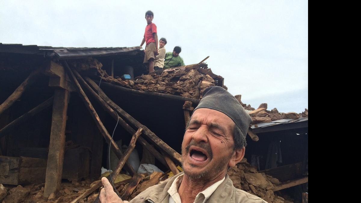 
A man describes damage that occurred during the earthquake in this remote village in Syadul, Nepal, on Tuesday
